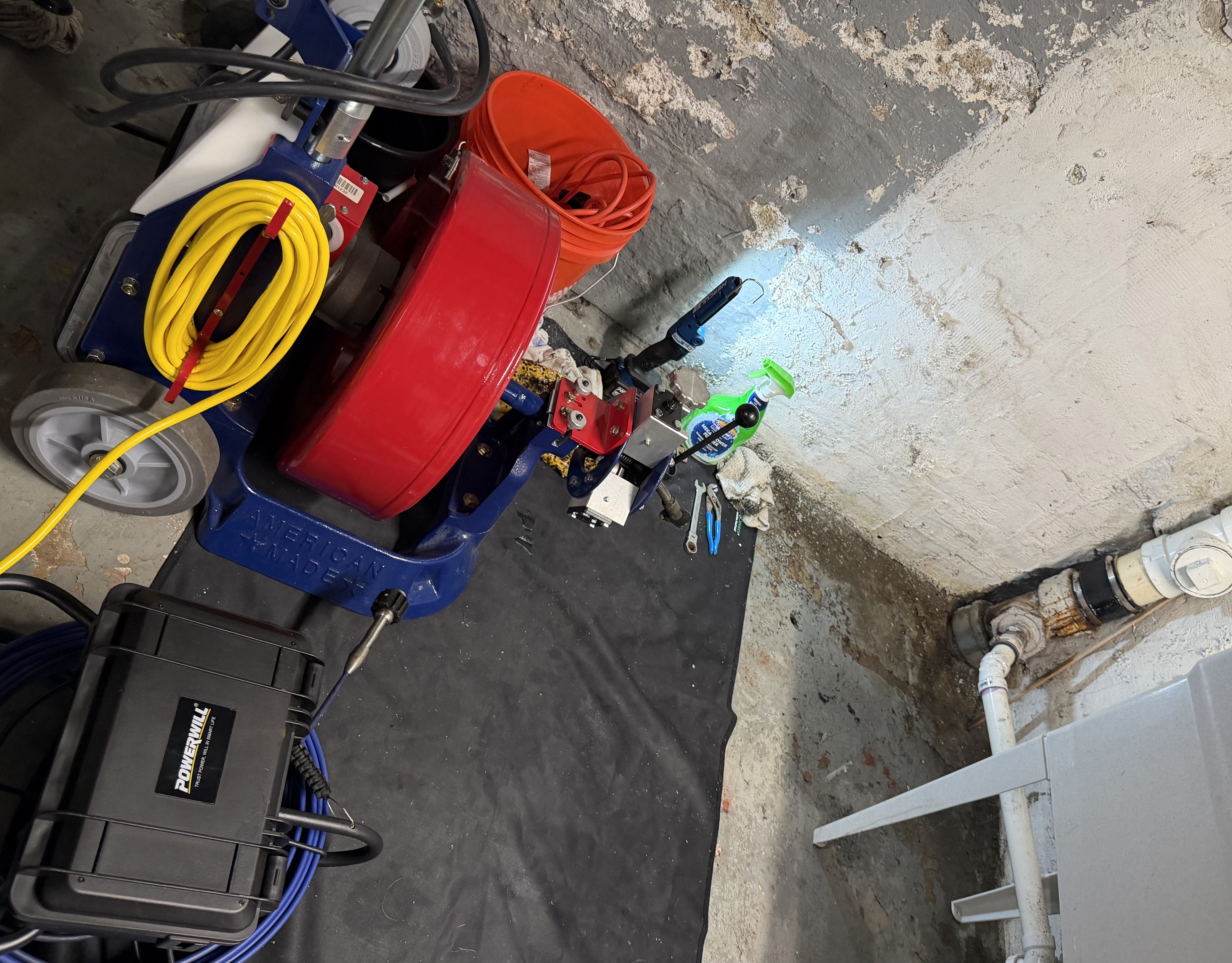 Power Snake set up to mechanically clear a blockage in a main sewer line.